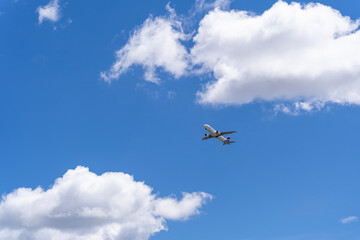 Fototapeta na wymiar airplane in the sky, clouds and blue sky