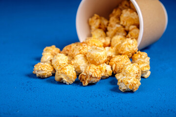 popcorn in a paper cup on a blue background