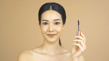 Portrait of Beautiful woman in Studio. She looking to camera with happy emotion.