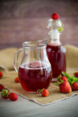 sweet cooked strawberry syrup in a glass decanter