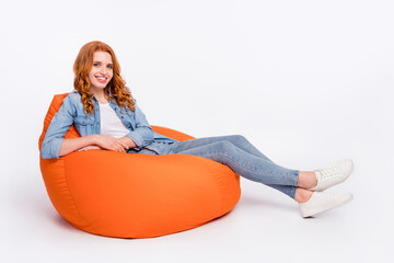 Full body photo of charming happy cheerful young woman smile sit bean bag smile isolated on grey color background