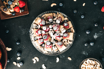 Breakfast pancake. A healthy breakfast with fruit. Pancake with fruit. Iced coffee and fruit. Dark background with pancakes and fruit.