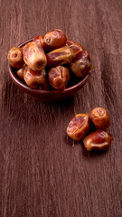 Dates in wooden bowl on background. dried dates fruit.