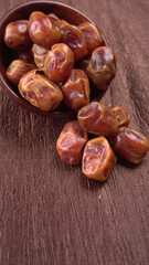 Dates in wooden bowl on background. dried dates fruit.