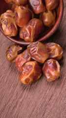Dates in wooden bowl on background. dried dates fruit.