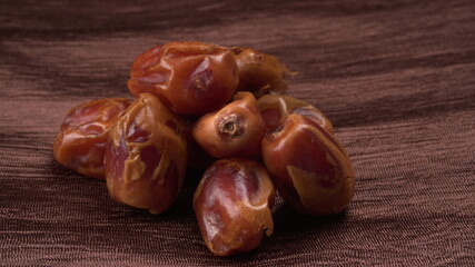 Dates in wooden bowl on background. dried dates fruit.