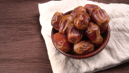 Dates in wooden bowl on background. dried dates fruit.