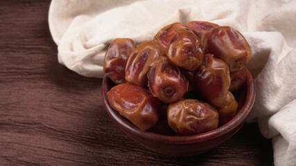 Dates in wooden bowl on background. dried dates fruit.