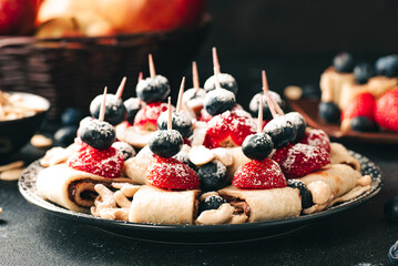 Breakfast pancake. A healthy breakfast with fruit. Pancake with fruit. Iced coffee and fruit. Dark background with pancakes and fruit.