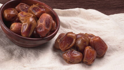 Dates in wooden bowl on background. dried dates fruit.