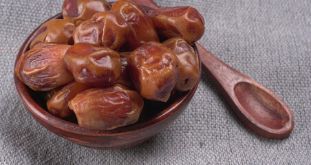 Dates in wooden bowl on background. dried dates fruit.