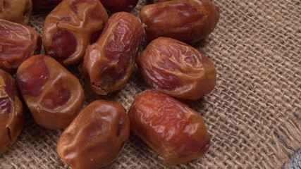 Dates in wooden bowl on background. dried dates fruit.