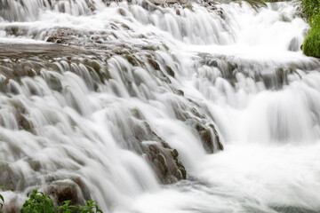 Long exposure picture of a river. Water texture, silk effect. Water moving over the rocks. Captured in 