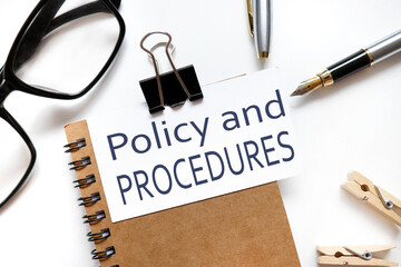 POLICIES and PROCEDURE. the inscription on the business card is attached to the notebook.