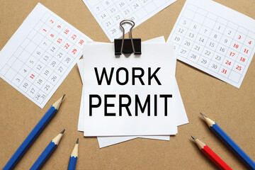 Work Permit. the text on the sticker near the calendar and karagdash. the paper is clamped with a...