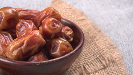 Dates in wooden bowl on background. dried dates fruit.