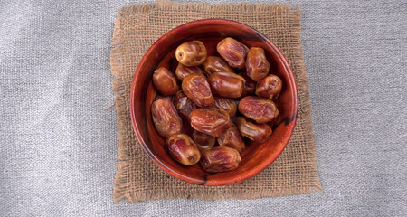 Dates in wooden bowl on background. dried dates fruit.