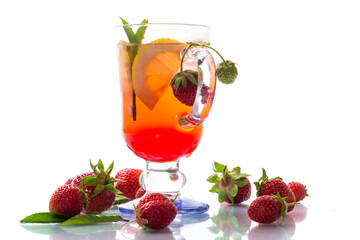 refreshing cool strawberry lemonade with lemon, ice and mint in a glass