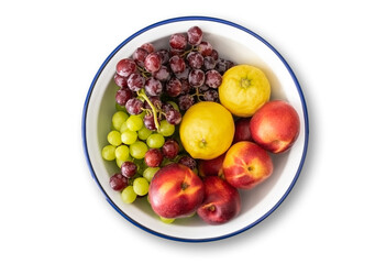 top view of white enamel bowl with blue rim filled with fresh fruits isolated on white background