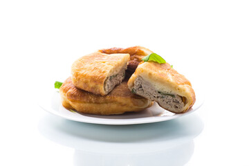 fried pies with meat in a plate on a white