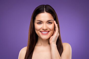 Portrait of attractive cheerful woman touching flawless skin laser peeling effect isolated over...