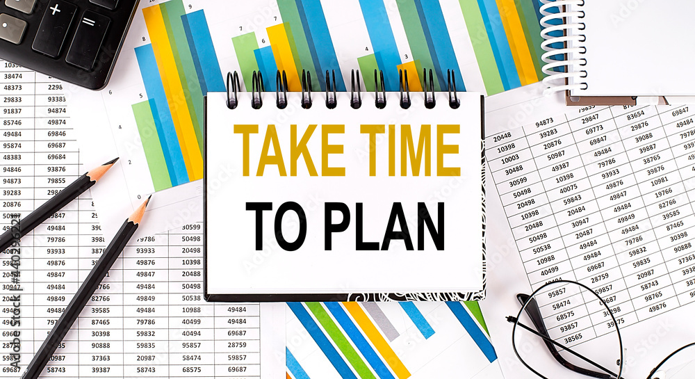 Poster closeup a notebook with text take time to plan , business concept image on chart background