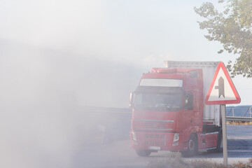 Truck reaching an area with a lot of dust that makes vision impossible.