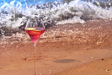 Wine glass with a cocktail by the sea.