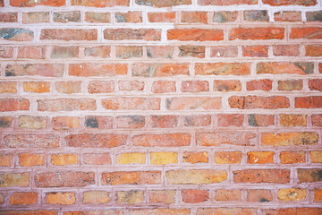 Old wall made of red bricks. Background with the surface of a brick wall.