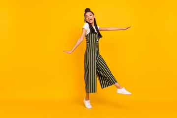 Full body photo of happy dark skin young woman good mood enjoy free time isolated on yellow color background