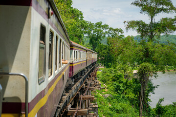 Fototapeta premium Thai Train on River Kwai Bridge of Kanchanaburi built in World War 2 , Thailand