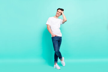 Fototapeta na wymiar Full length body size photo guy in white t-shirt looking copyspace nice haircut isolated vivid turquoise color background