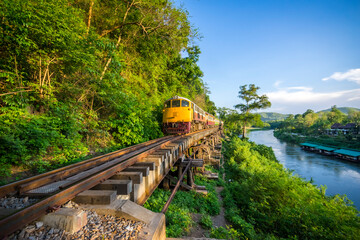 Fototapeta premium Thai Train on River Kwai Bridge of Kanchanaburi built in World War 2 , Thailand
