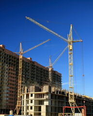 Tower cranes are working on the construction of a new house. Lifting crane.