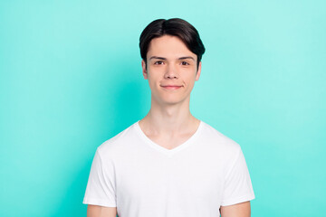 Photo of brunet hairdo teen guy wear white t-shirt isolated on bright teal color background