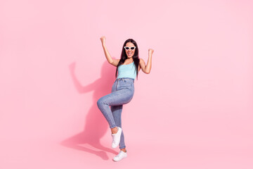 Full length body size view of attractive cheerful lucky girl dancing rejoicing isolated over pink pastel color background