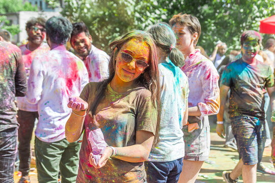 the pretty young woman in the color fest, colored face of the young woman, color festival in india