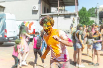 the pretty young boy in the color fest, colored faces of the peoples, color festival in india