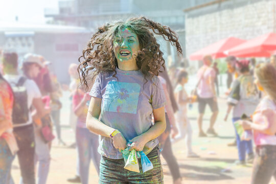the pretty young woman in the color fest, colored face of the young woman, color festival in india