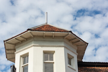 old steeple with windows against the blue sky