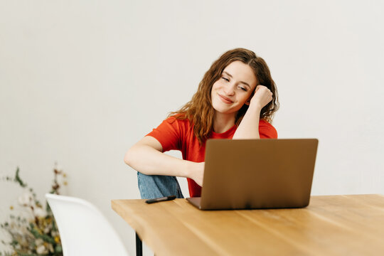 Young woman watching media or reading on a laptop computer