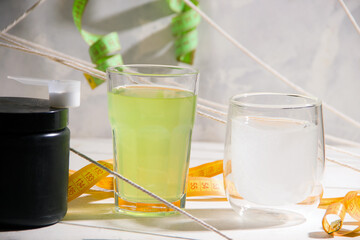 Sports drinks in glasses on a gray background.
