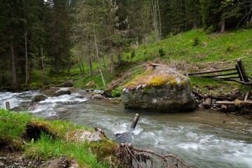 Naklejka na ściany i meble wild river in the remote mountain area Hochrindl in the Austria region of Carinthia