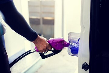 hand refilling the car with fuel at the gas  station, car in gas station, refilling the car with fuel at the refuel station, the concept of fuel energy.