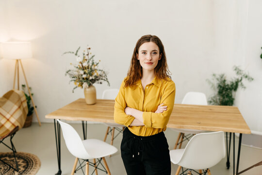 Thoughtful Intense Young Woman Standing Staring At Camera