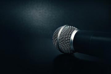 microphone on a black background. black texture with a microphone. music and sound concept