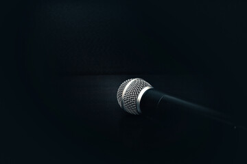 professional microphone on a black background. sound and speaker concept. microphone and text in...