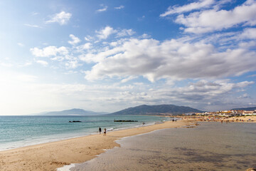 View of golden mile beach in Tarifa city, Cadiz , Costa de Luz, Spain. Famous travel destination. Cloudy sky.
