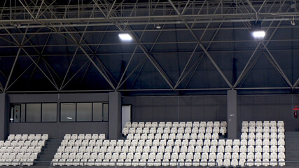 empty spectator seating rows with building construction
