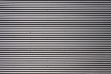 Obraz premium Texture of a silver corrugated sheet metal aluminum facade.
